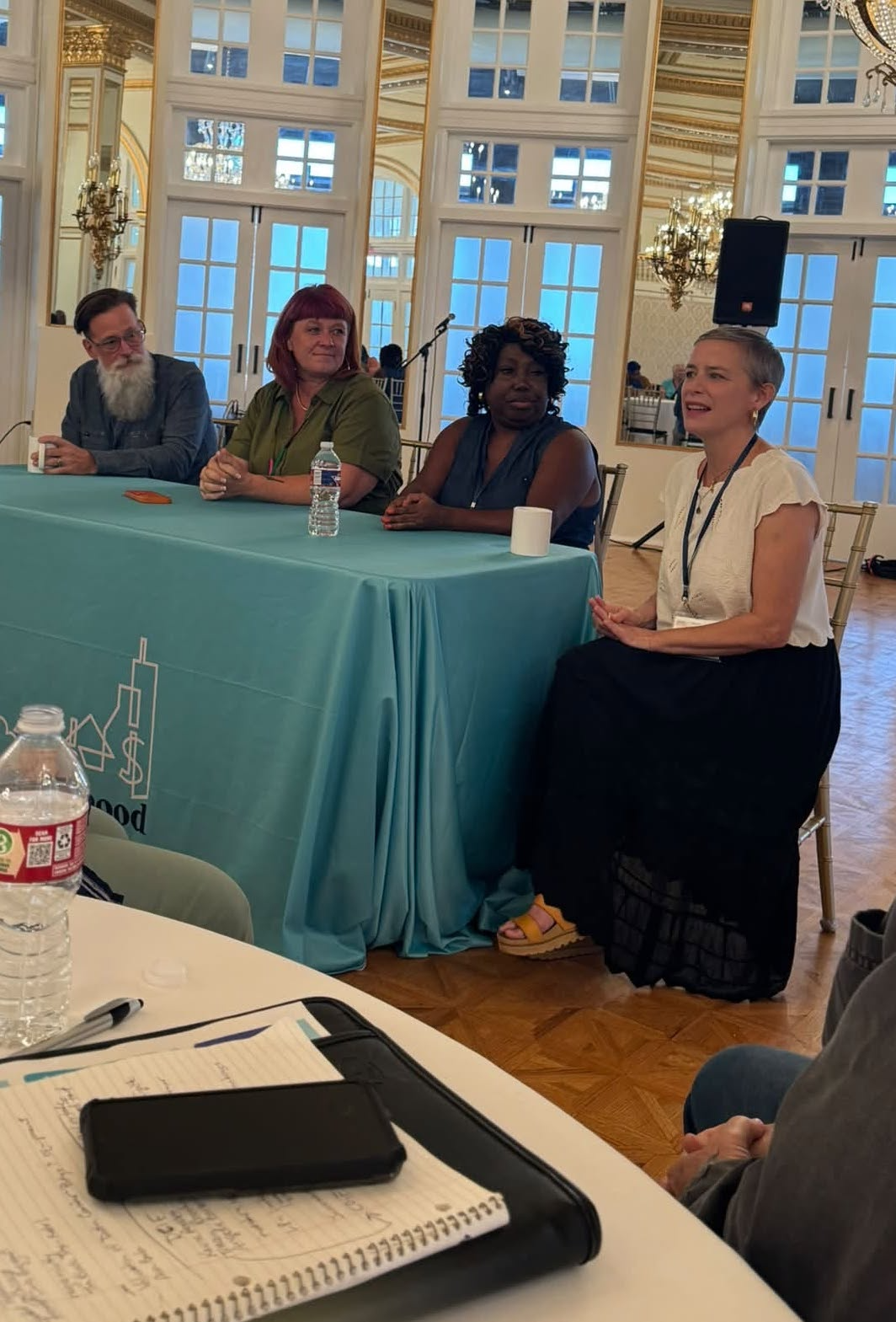 Taylor community members speak on a conference panel