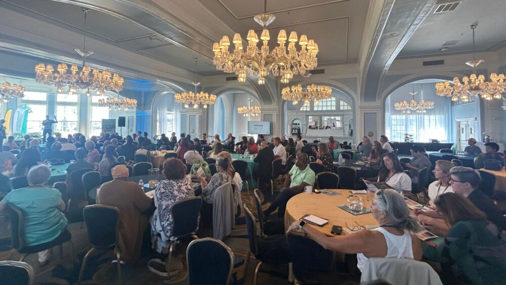 Attendees at round tables in the ballroom during the Neighborhood Economics conference