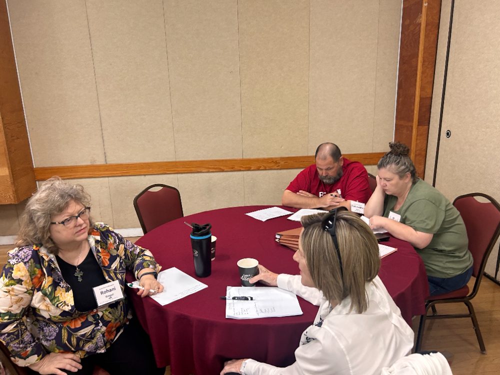 A table group talks together during small-group time